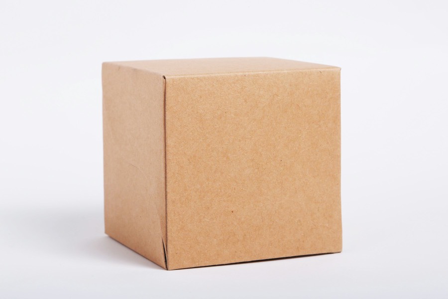 Brown shipping box in front of a white background