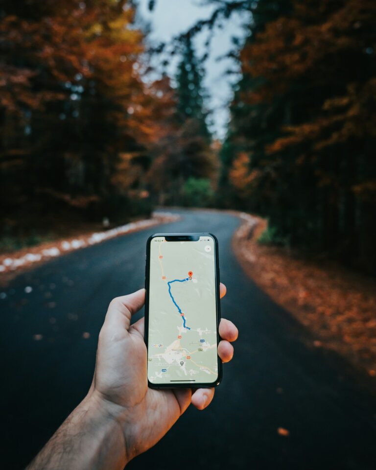 Hand hält ein Smartphone mit einer Navigationskarte